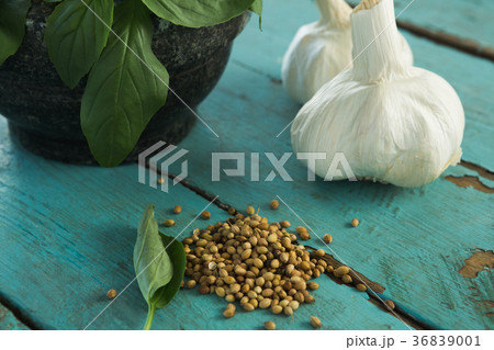 Mortar and pestle with herbs and spices on wooden table 36839001