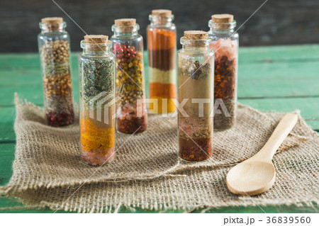 Various spices in bottles on wooden table Various spices in bottles on wooden table 36839560