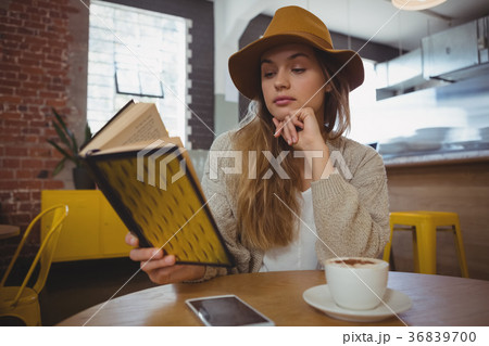Woman reading book in cafe Woman reading book in cafe 36839700