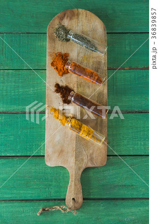 Various spices spilling out of bottles Various spices spilling out of bottles 36839857
