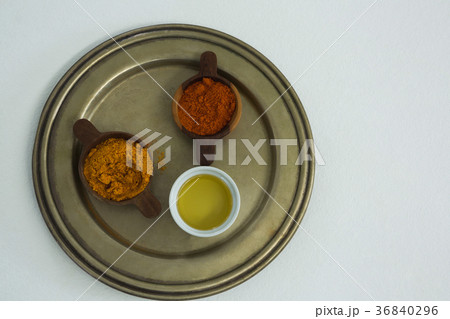 Spices powder with oil in bowl 36840296