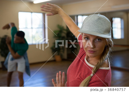 Portrait of female dancer with friend practicing Portrait of female dancer with friend practicing 36840757