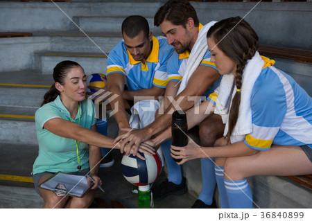 Coach with volleyball players taking oath 36840899