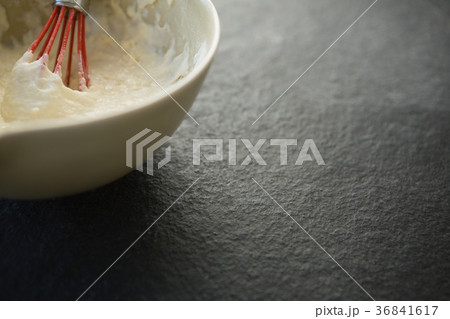 Overhead view of batter with wire whisk in bowl 36841617