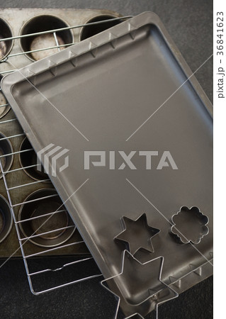 Various pastry cutter and baking sheet with cooling rack on muffin tin 36841623