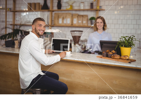 Portrait of smiling male owner and waitress at counter Portrait of smiling male owner and waitress at counter 36841659
