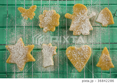 Directly above shot of powdered sugar on cookies over cooling rack Directly above shot of powdered sugar on cookies over cooling rack 36842286