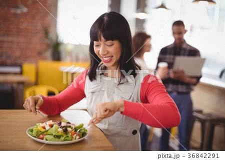 Happy young woman eating fresh healthy salad at coffee shop Happy young woman eating fresh healthy salad at coffee shop 36842291