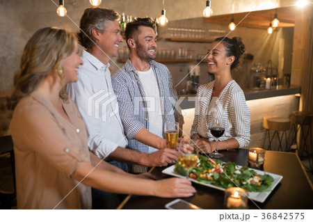 Group of friends interacting with each other 36842575