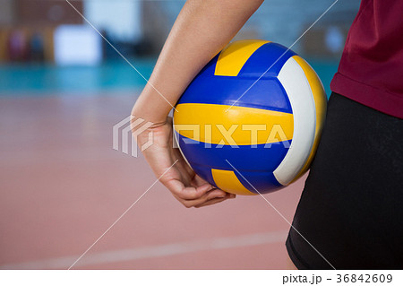 Female player holding volleyball in the court Female player holding volleyball in the court 36842609