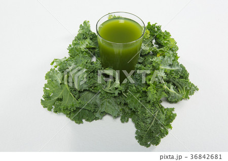High angle view of juice amidst kale leaves High angle view of juice amidst kale leaves 36842681