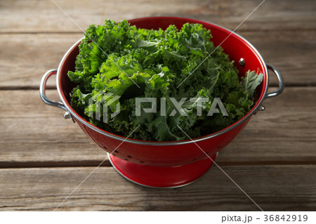 Close-up of kale in colander on table 36842919