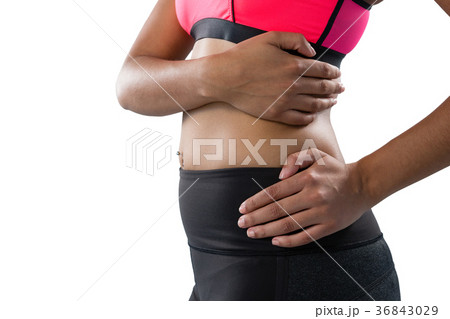 Mid section of female athlete with back pain Mid section of female athlete with back pain 36843029