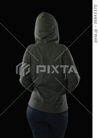 Rear view of female athlete in hooded jacket Rear view of female athlete in hooded jacket 36843370