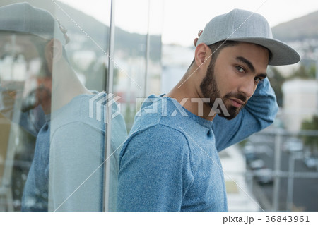 Handsome man leaning on glass 36843961