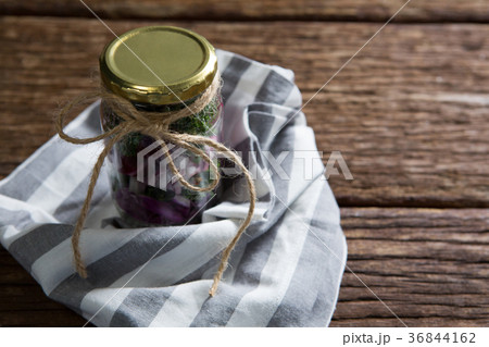 Pickled vegetables in jar with cloth 36844162