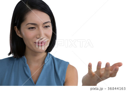 Female executive pretending to hold invisible object 36844163