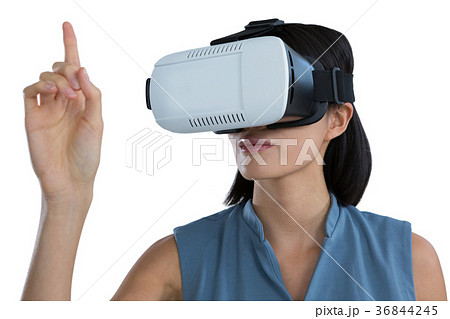 Female executive gesturing while using virtual reality headset 36844245