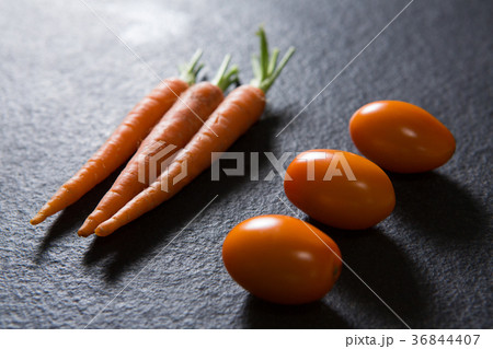 Carrots and tomatoes on black background 36844407