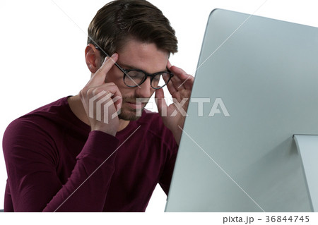 Stressed man sitting at desk Stressed man sitting at desk 36844745