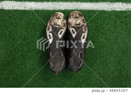 Cleats kept upside down on artificial grass 36845307