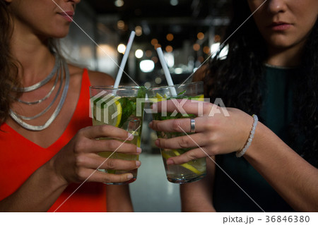 Mid section of friends toasting mocktails 36846380
