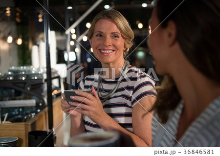 Happy woman interacting while having coffee Happy woman interacting while having coffee 36846581