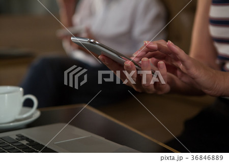 Mid section of woman using mobile phone Mid section of woman using mobile phone 36846889