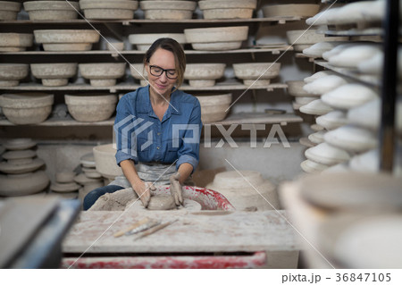 Female potter molding a clay 36847105