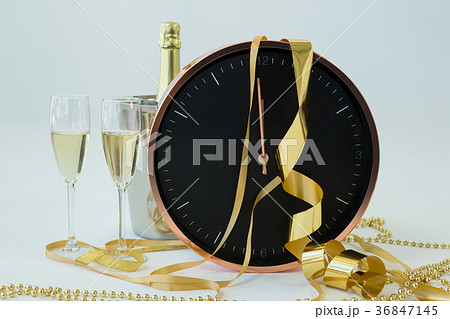 Champagne with clock and glass on white background 36847145