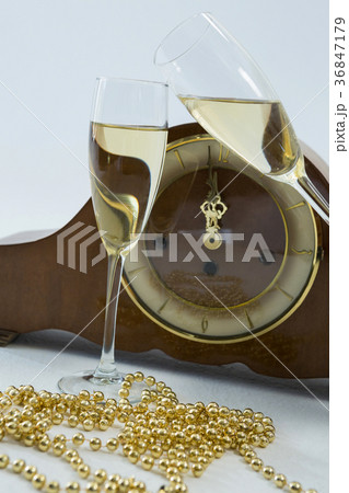 Champagne glass and clock on white background Champagne glass and clock on white background 36847179