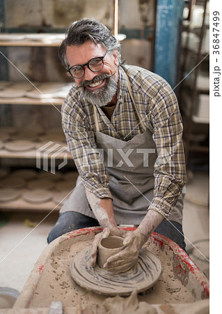 Portrait of male potter molding a clay 36847499
