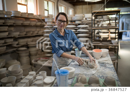 Portrait of female potter molding a clay 36847527