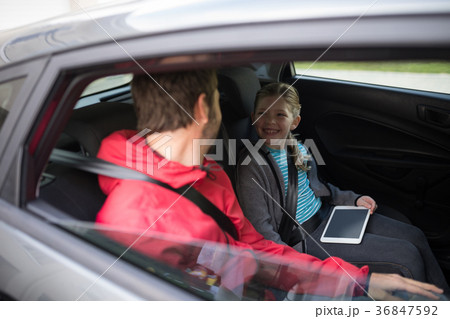 Father and daughter interacting in the back of the car 36847592