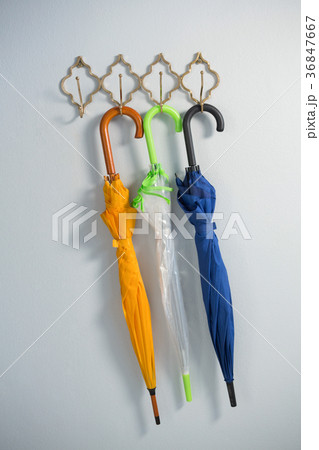 Colorful umbrellas hanging on hook 36847667
