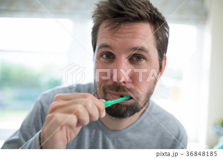 Man brushing teeth in the bathroom Man brushing teeth in the bathroom 36848185