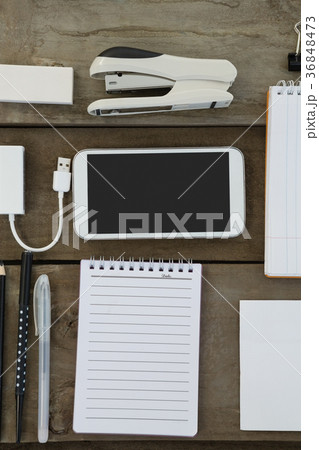 Office supplies and mobile phone on wooden plank 36848473