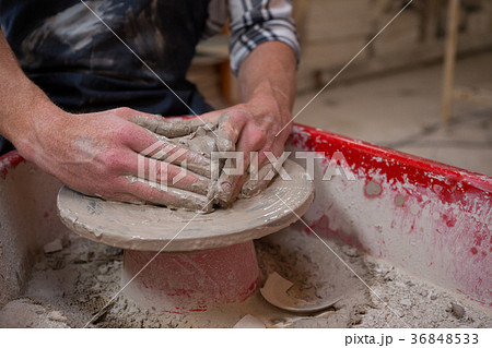 Male potters hand making a pot Male potters hand making a pot 36848533