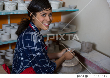 Portrait of female potter molding a clay 36848615