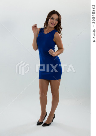 Woman in blue dress posing against white background Woman in blue dress posing against white background 36848833