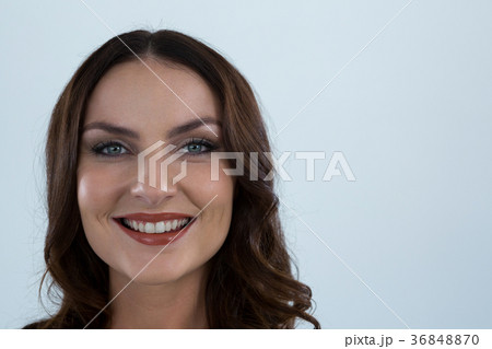 Smiling woman looking at camera against white background Smiling woman looking at camera against white background 36848870