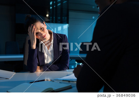 Tensed businesswoman sitting at desk 36849036