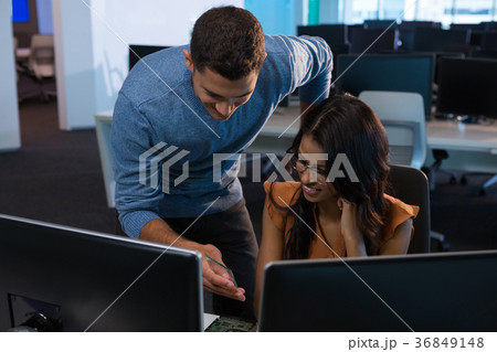 Male and female executive using digital glass sheet 36849148