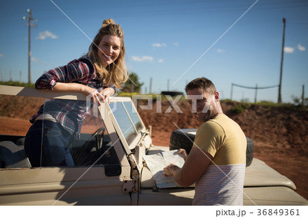 Couple looking at map on a sunny day Couple looking at map on a sunny day 36849361