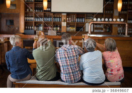 Happy friends having drinks in bar 36849607