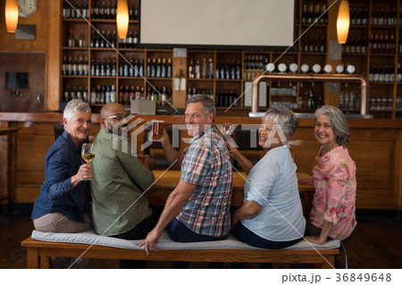 Happy friends having drinks in bar 36849648