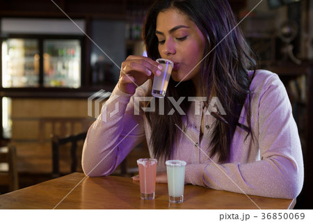Woman drinking tequila shot Woman drinking tequila shot 36850069