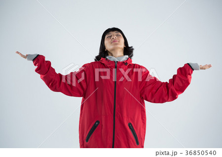 Blissful woman standing with arms outstretched Blissful woman standing with arms outstretched 36850540