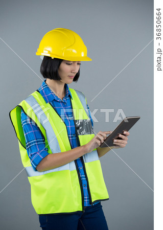 Female architect using digital tablet Female architect using digital tablet 36850664