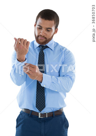 Businessman putting the cuff buttons 36850703